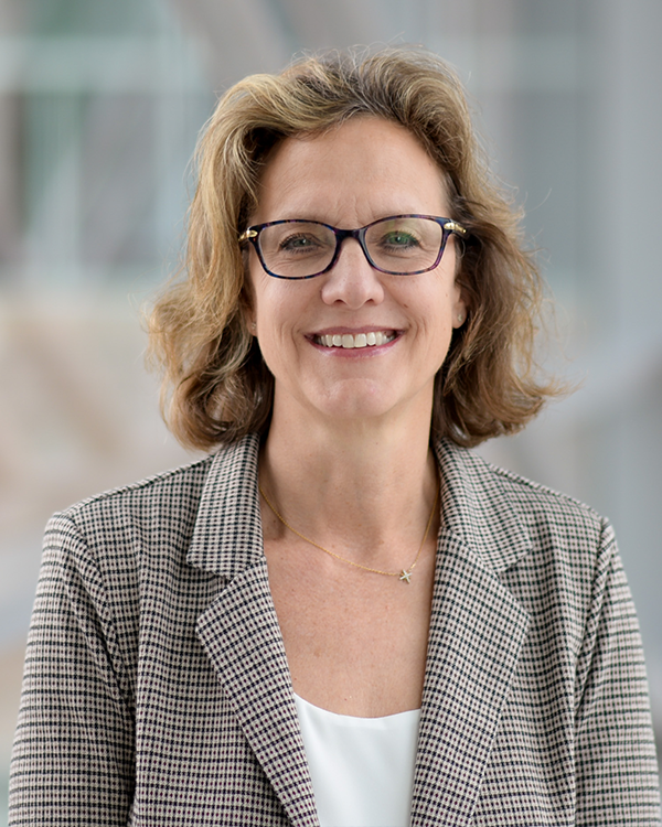 Middle age woman with glasses and a blonde long bob