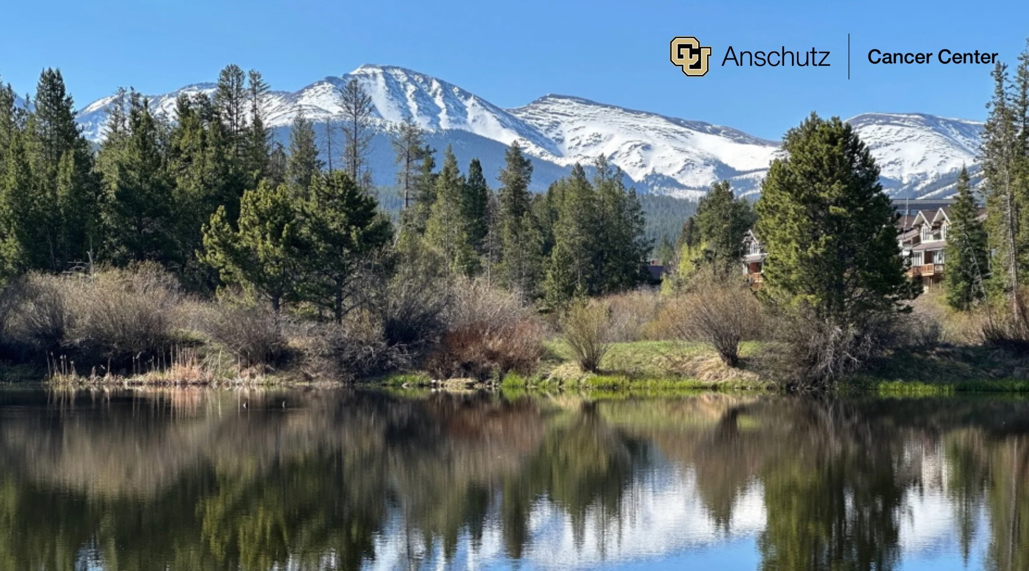 LakewithtreesandmountainsinthebackgroundwithCUAnschutzCancerCenterLogo