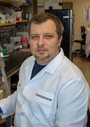 Dr. Igor Kogut professional photo, wearing a white lab coat