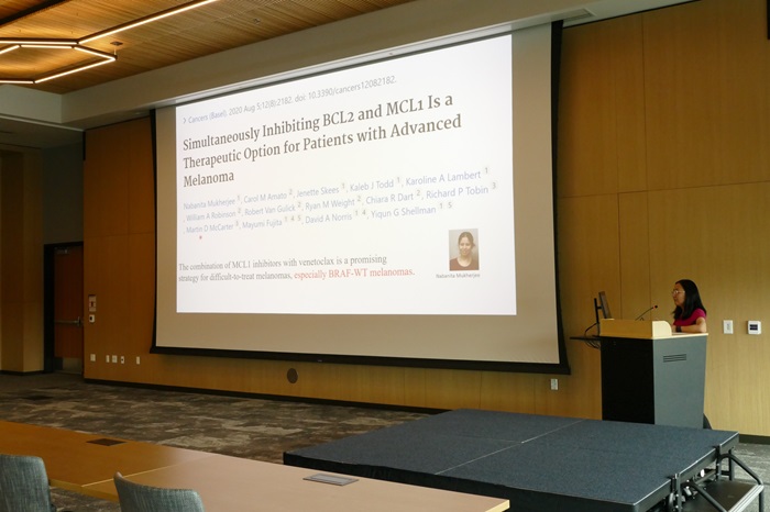 Dr. Yiqun Shellman at a podium sharing her presentation