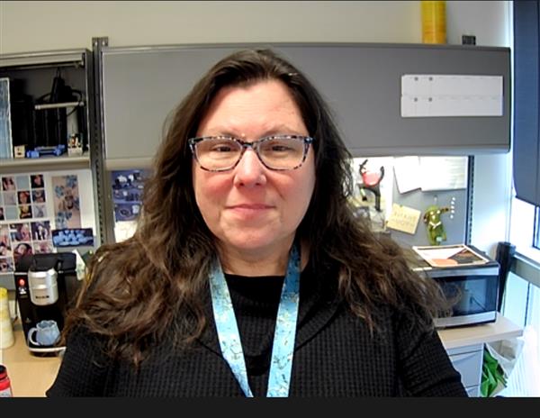 Christine Childs sitting in her office, smiling