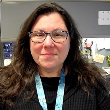 Christine Childs sitting in her office, smiling