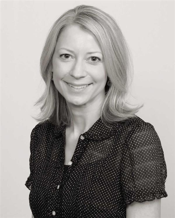 Lori Prok, MD smiling, wearing a black blouse