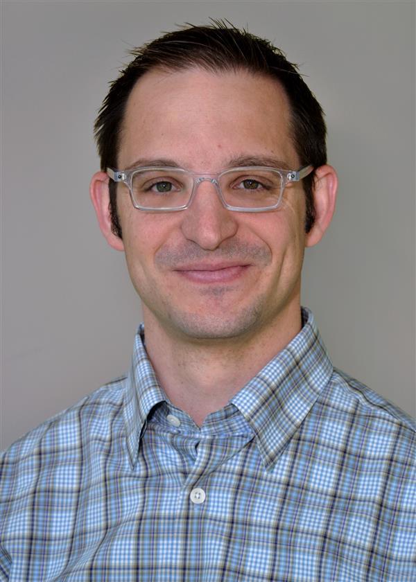 Professional headshot of Joshua Wisell, MD, smiling