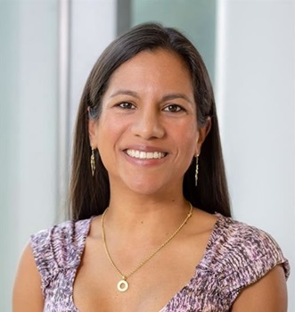 Carla Torres-Zegarra smiling and wearing a purple blouse