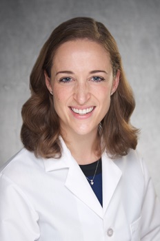 Kirsten Berrebi's professional headshot, smiling and wearing a white coat.