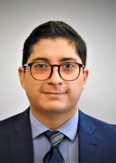 Professional photo of Ramiro Rodriguez, MD, smiling and wearing a blue suit jacket and tie.