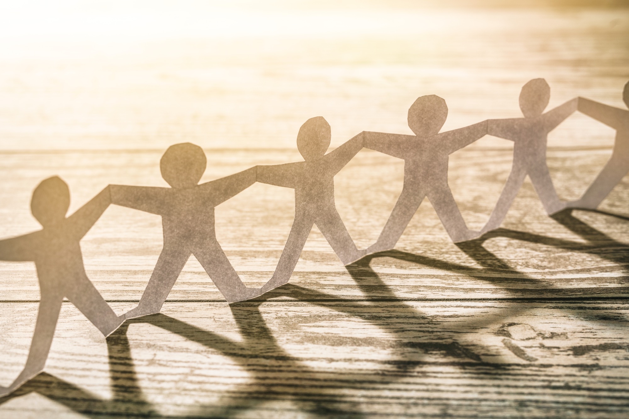 Picture of paper people holding hands