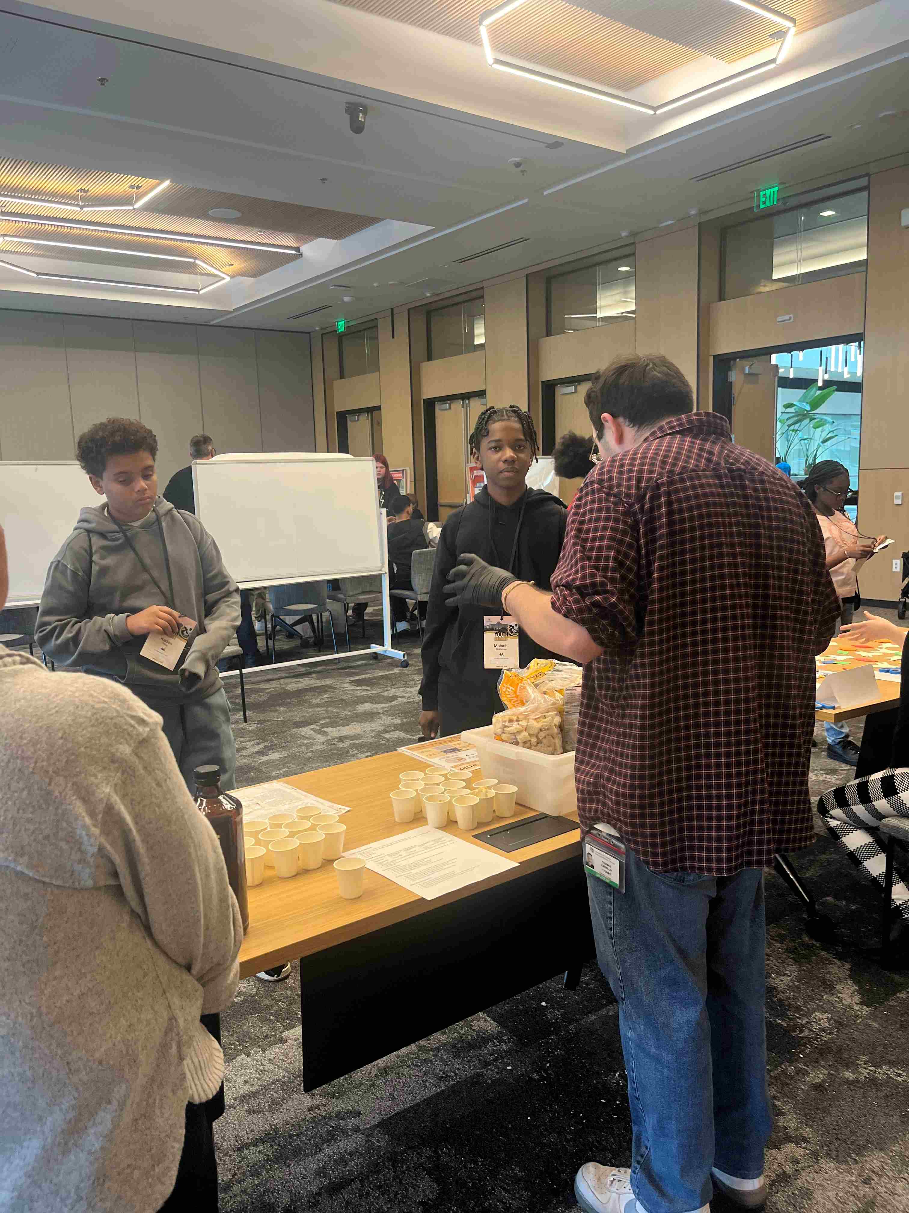 Photooftablewithyouthscienceactivitywithvolunteers