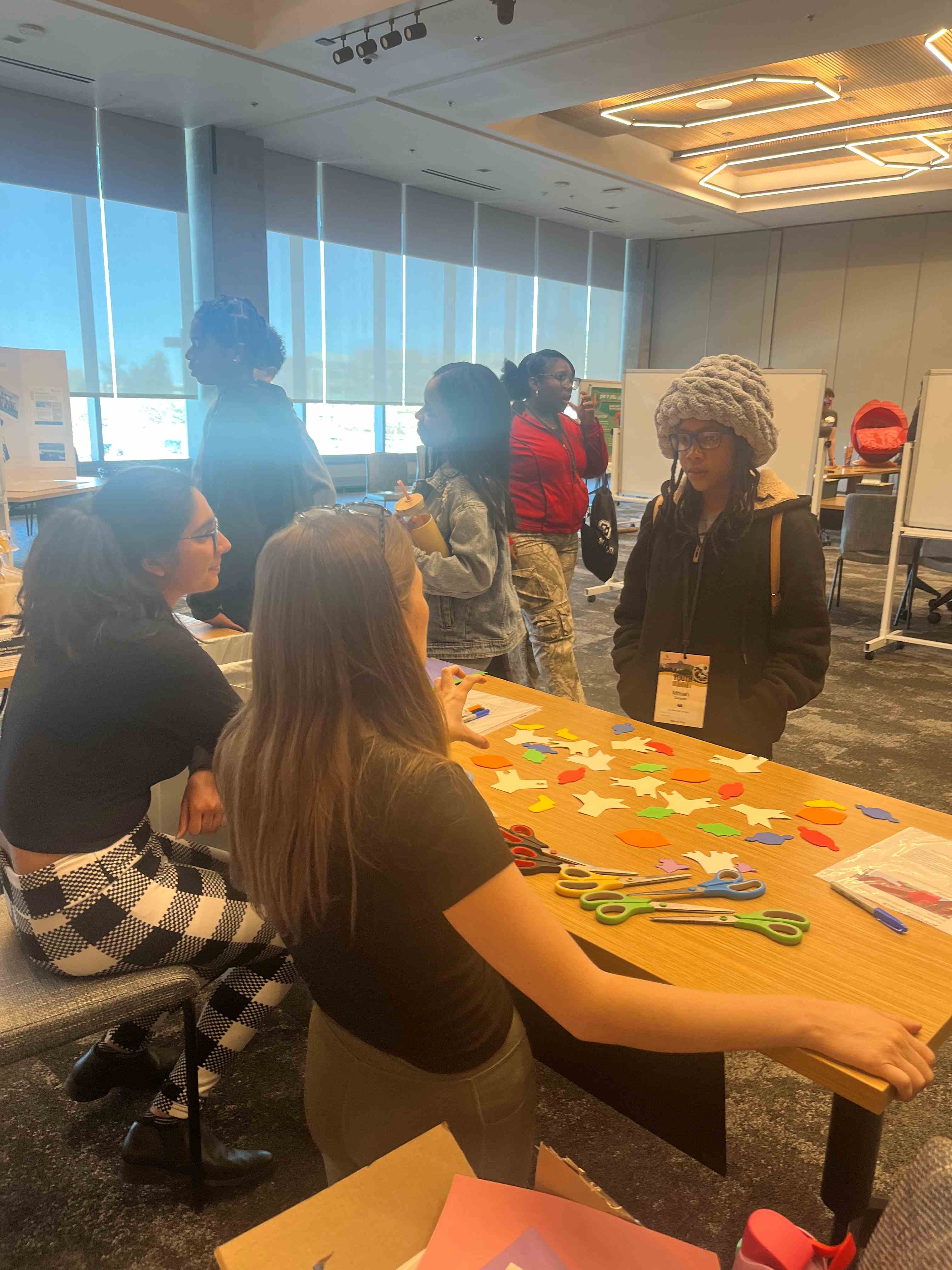 Photooftablewithyouthscienceactivitywithvolunteersandstudents