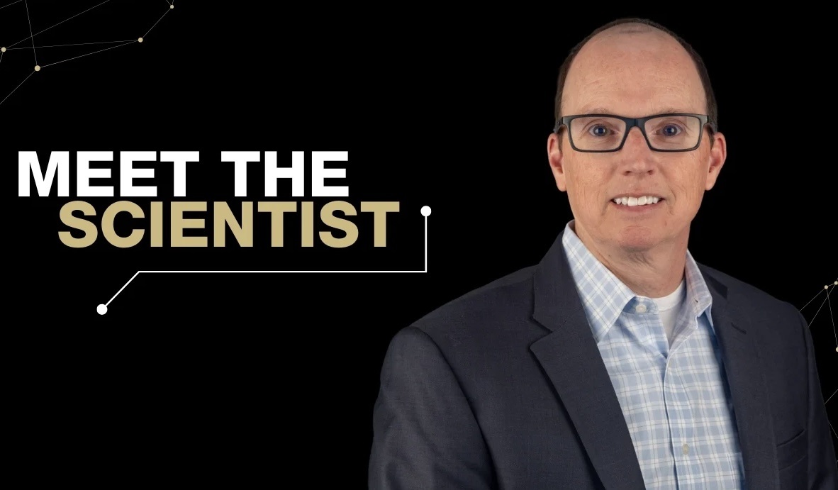 ImageofTemMorrisonsmilingwiththetextmeetthescientisttotheleftandablackbackground