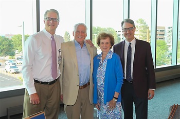 group of 4 doctors, standing and smiling