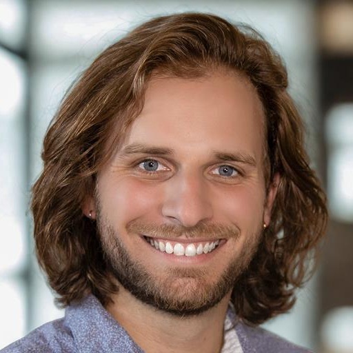 man smiling in a headshot