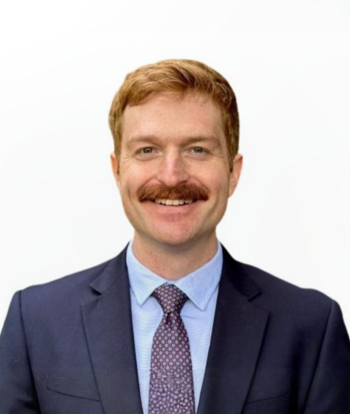 man smiling with a blue suit on