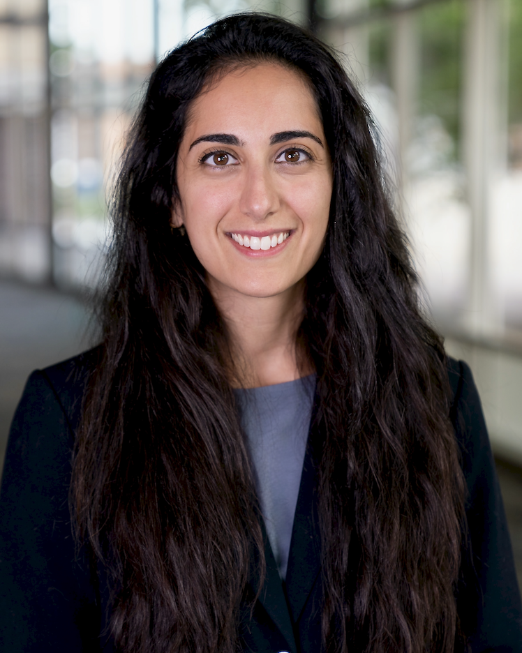 person smiling with long dark hair for a headshot photo
