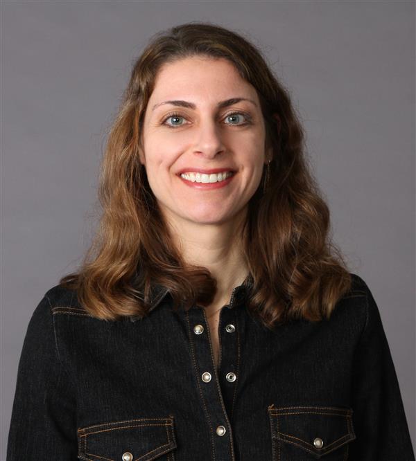 female smiling wearing a black shirt