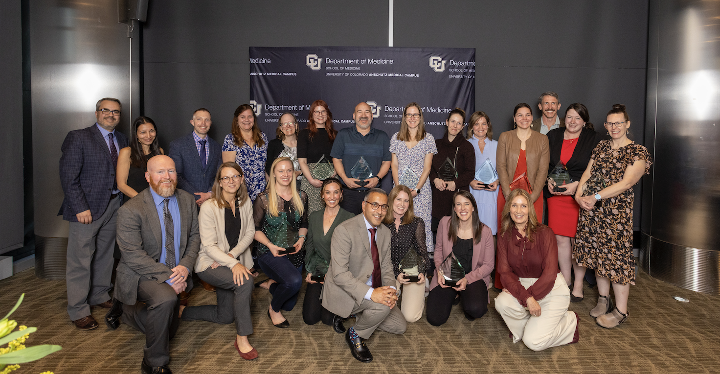 a group of doctors and staff holding an award