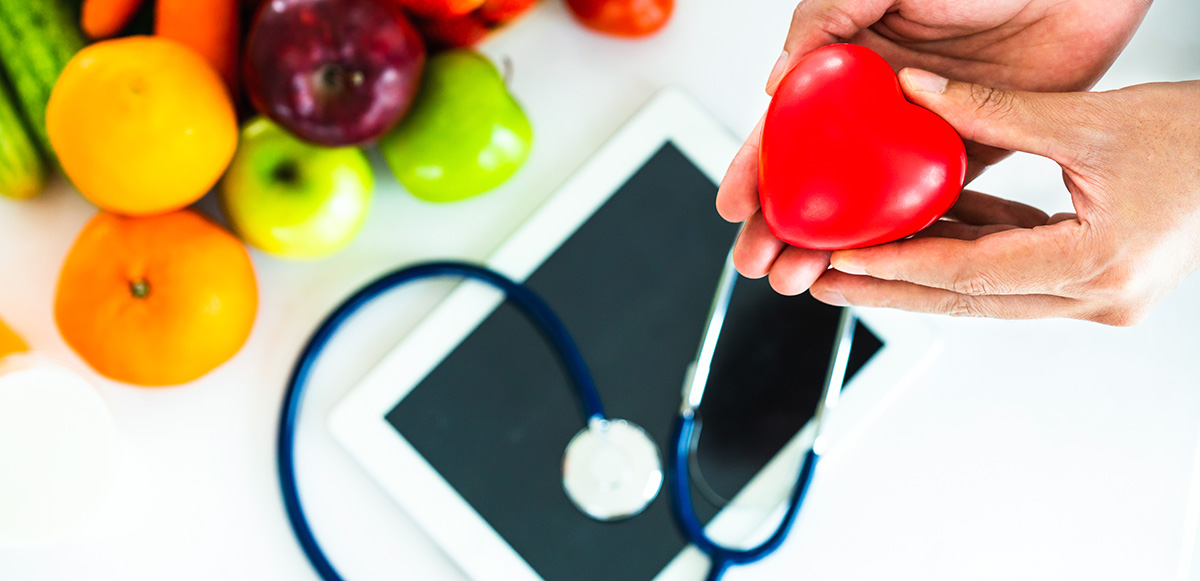 red heart, stethoscope, fruit and vegetables