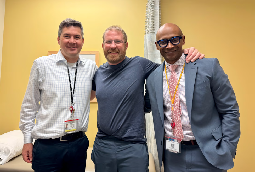 Andy in an exam room with Dr. Berry-Candelario and Lawrence Cloutier, PA-C