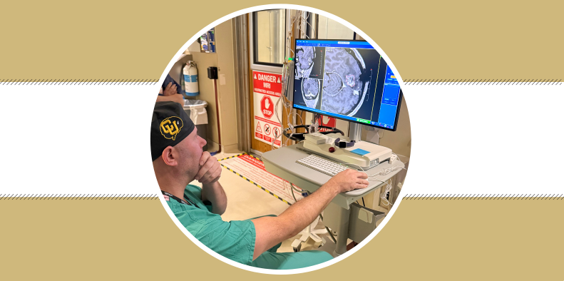Peter Fecci, MD, PhD, looking at MRI images of a patient's brain.