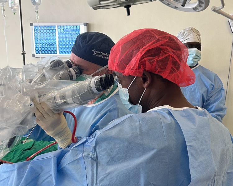 Dr. Lillehei in the OR with an MOI neurosurgeon in the OR in Tanzania.