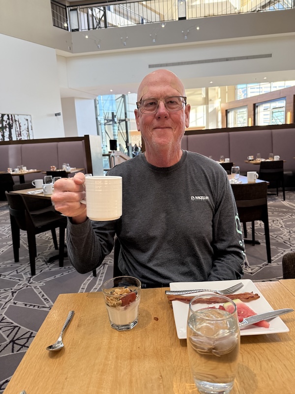 Stephen Dillon holding up a cup the day after surgery