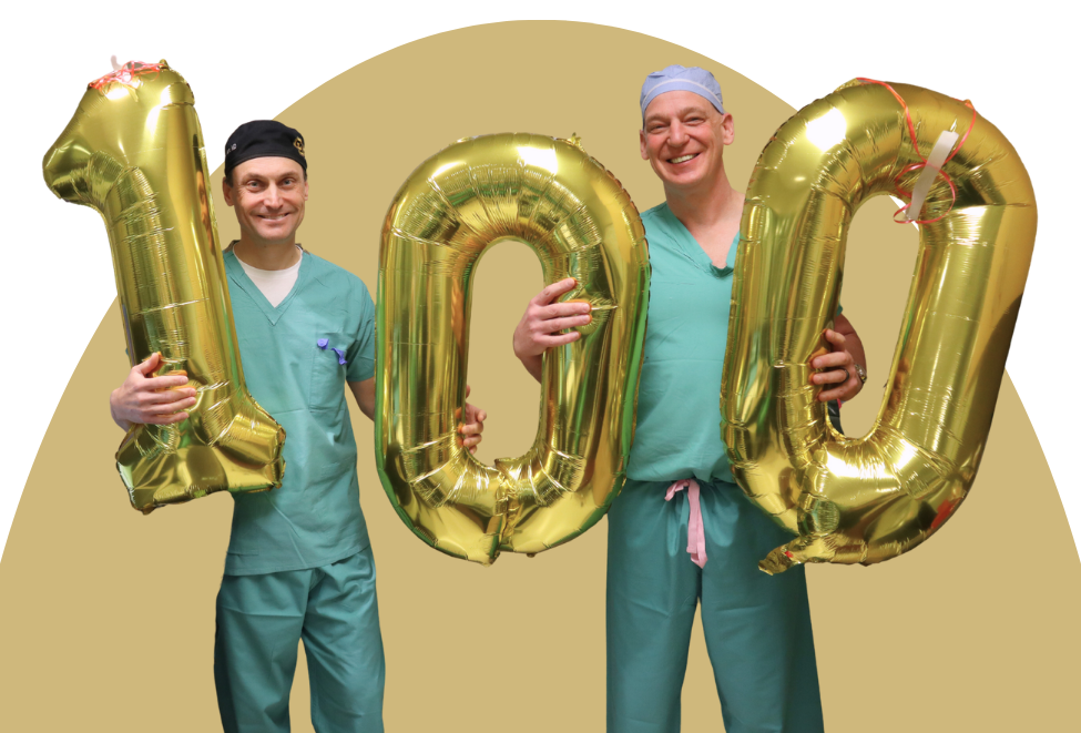 Drew Kern, MD, and Steve Ojemann, MD, holding a 100 balloon in the MRI suite