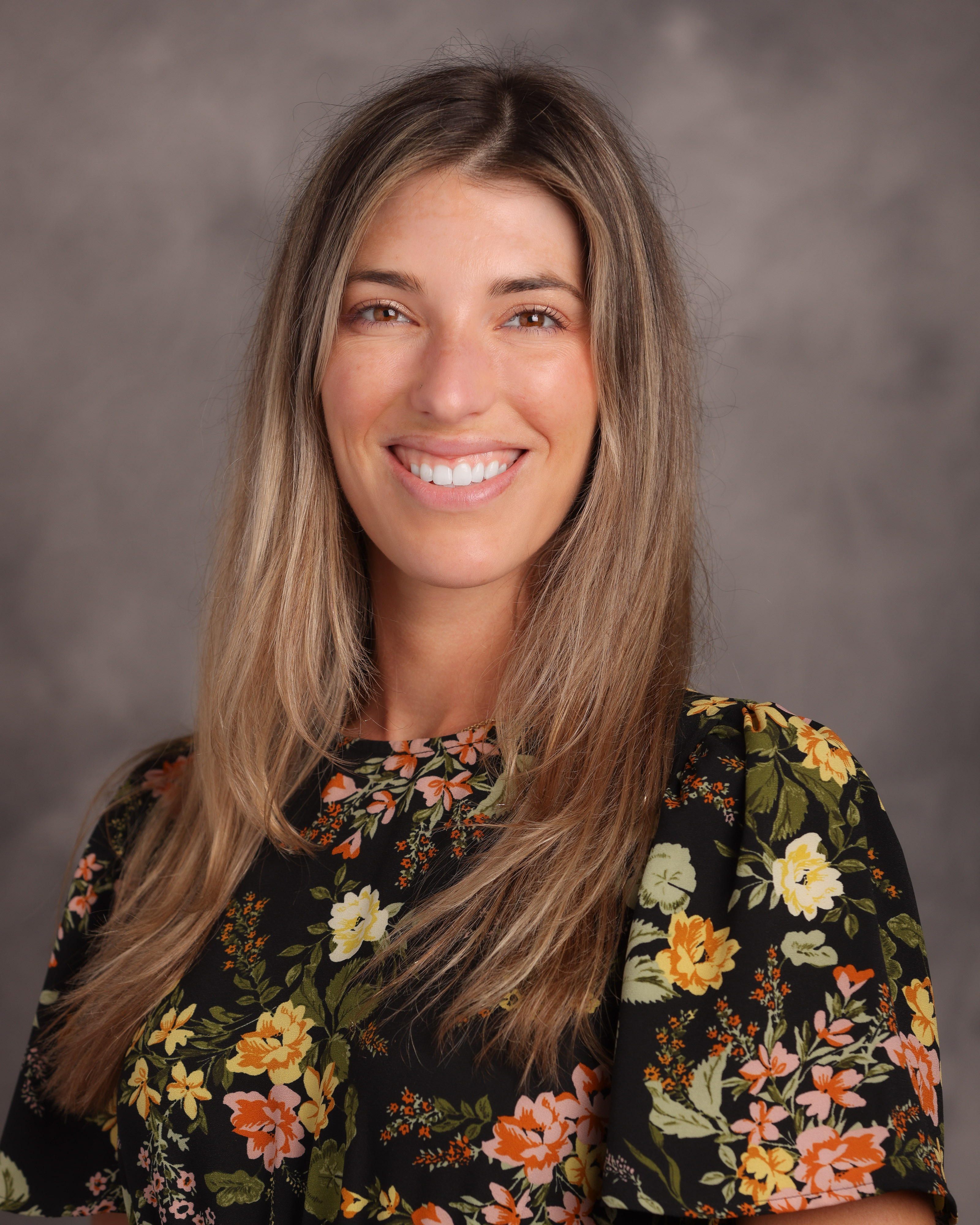 female doctor wearing a black shirt with pink and yellow flowers