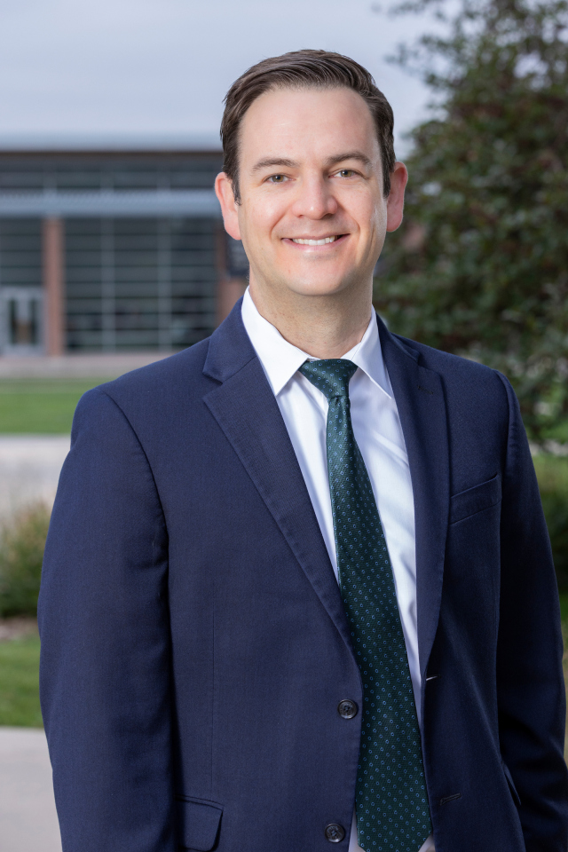 male doctor in a blue suit outside