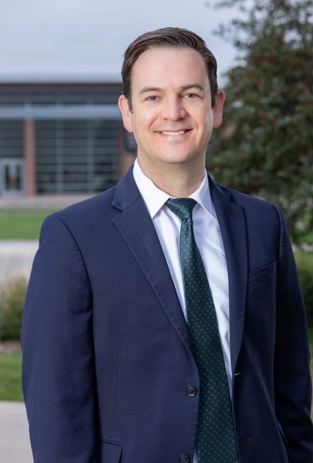 male doctor in a blue suit outside