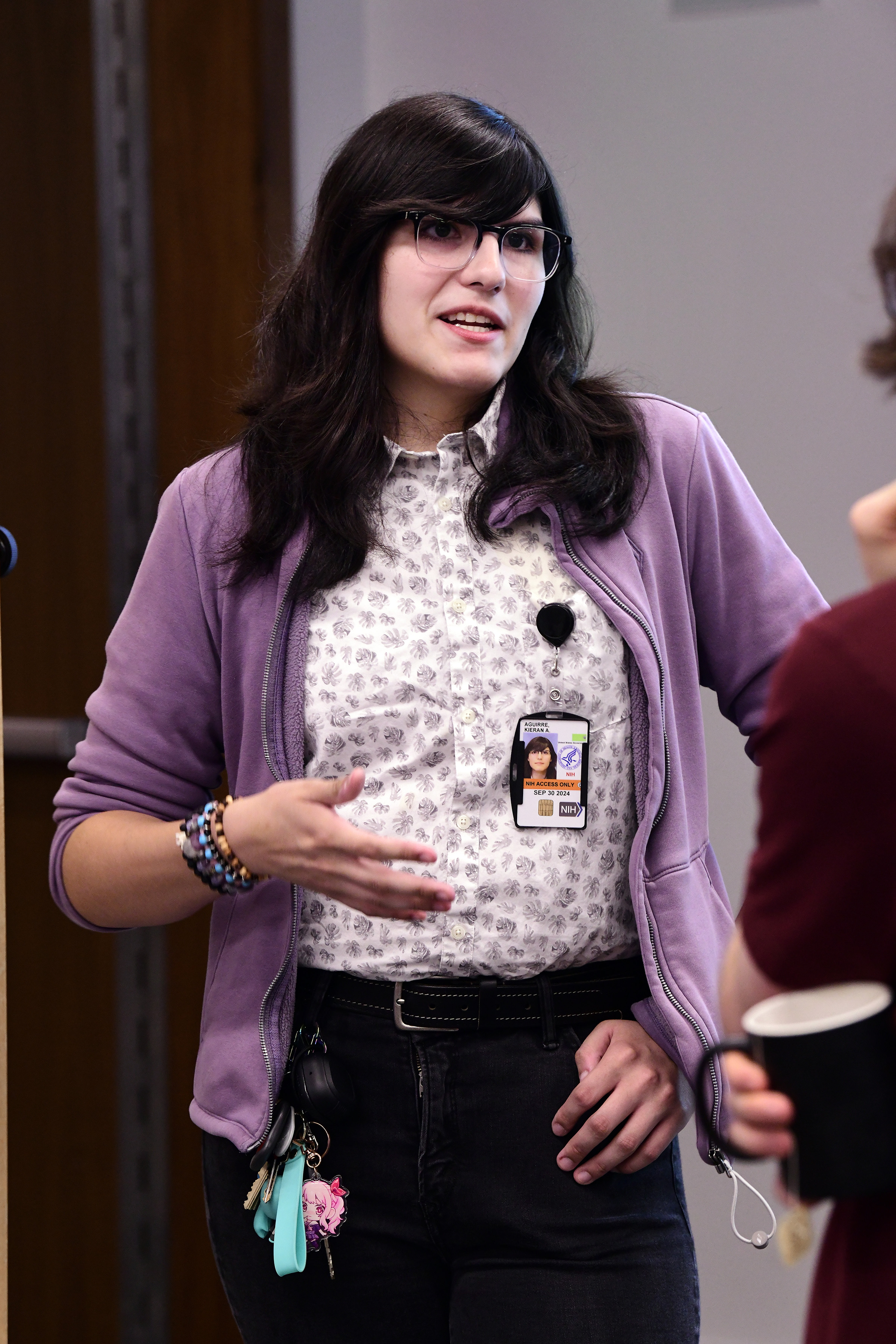 girl with dark hair, glasses, and purple blazers