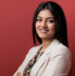 female doctor in white blazer, smiling