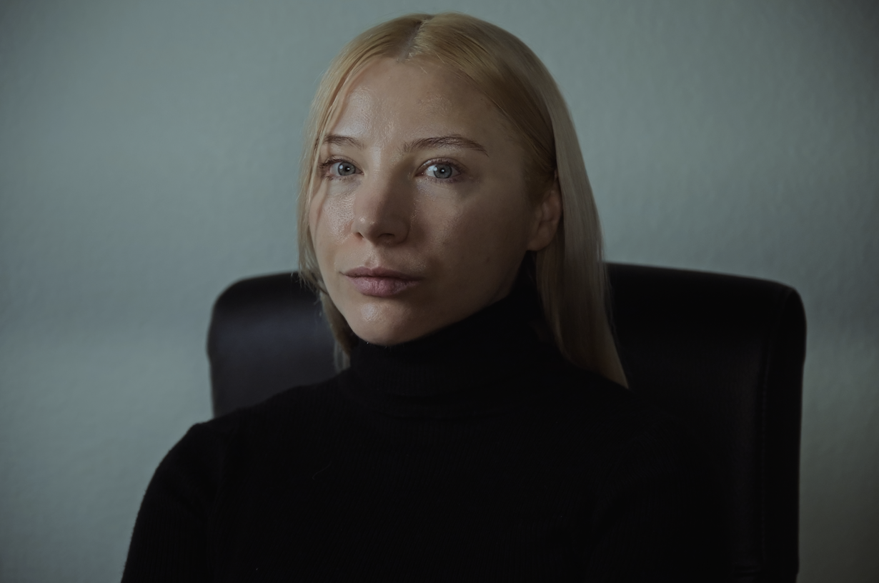 female woman headshot, blonde hair and black turtle neck