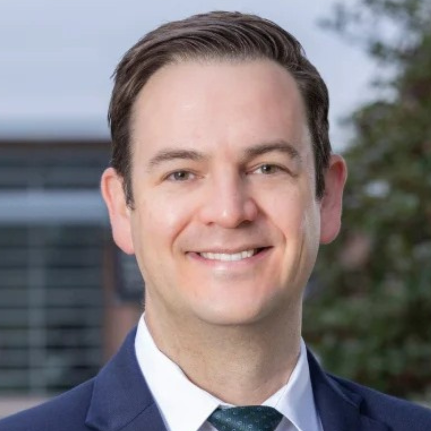 male doctor smiling for a headshot