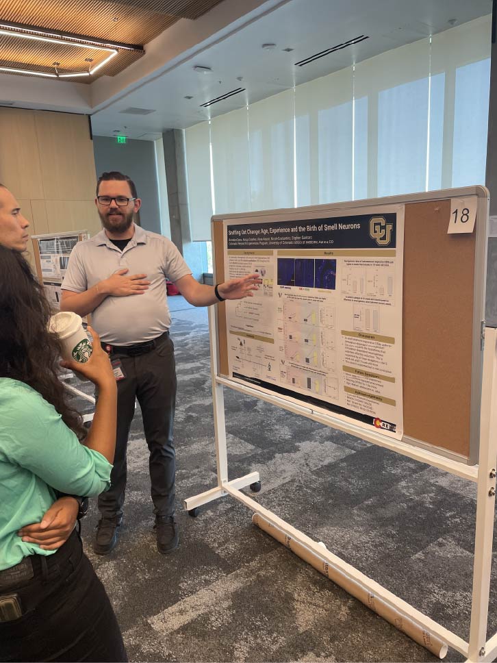 Brandon presenting research at summer symposium 2025