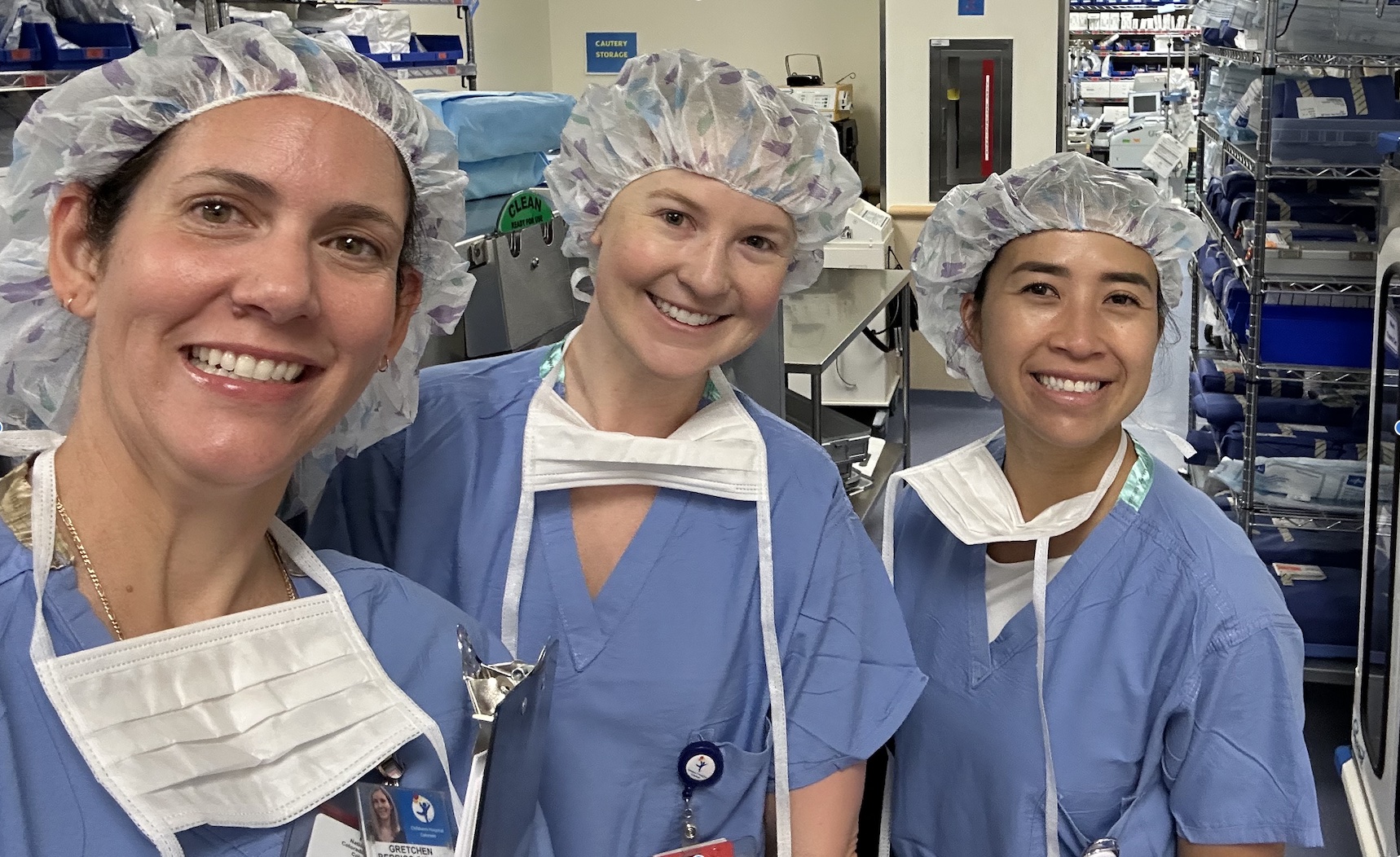 Three people getting ready for a neurosurgery procedure.