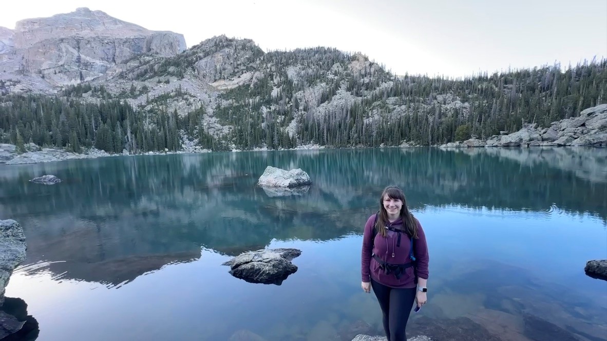Photo of Dr. Deanna Claus by a mountain lake.