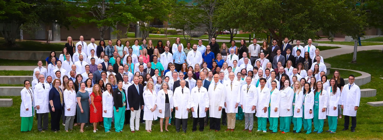 Dept of Surgery 2024 faculty, staff, and trainees group photo on lawn