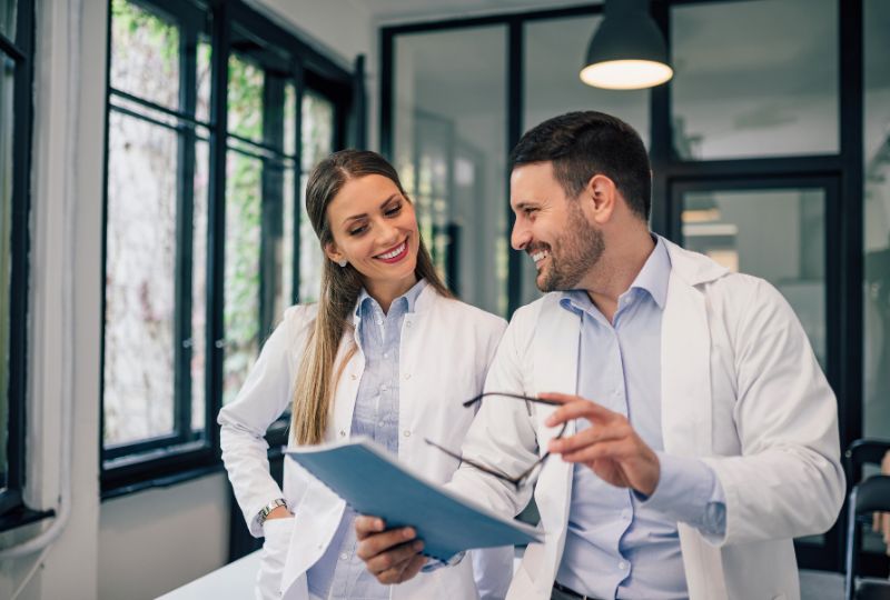 Two doctors speaking with each other.