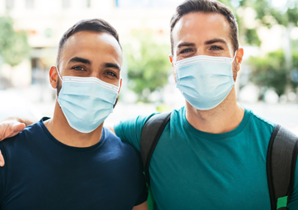 Picture of two men wearing surgical masks
