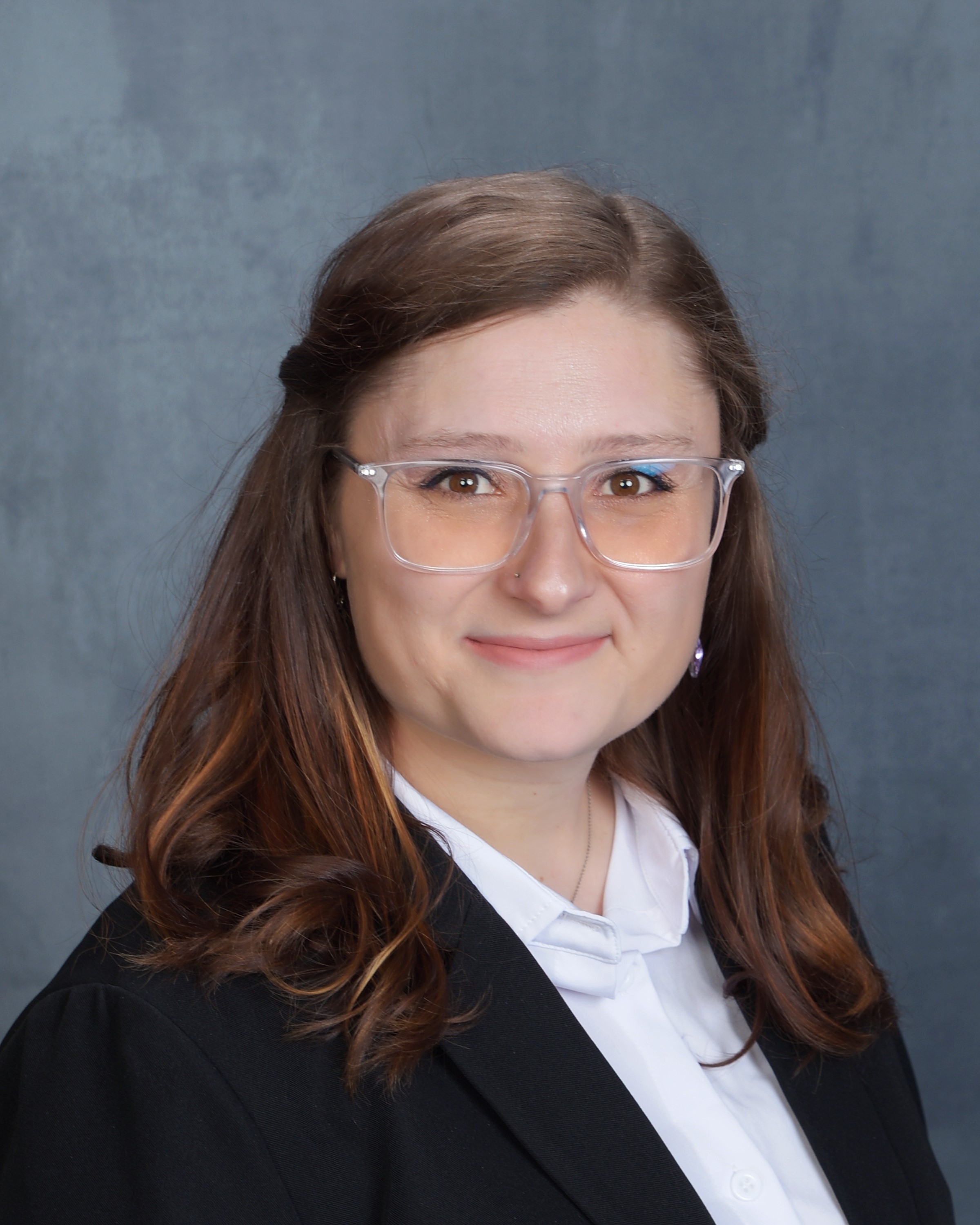 Professional headshot of woman in blazer.