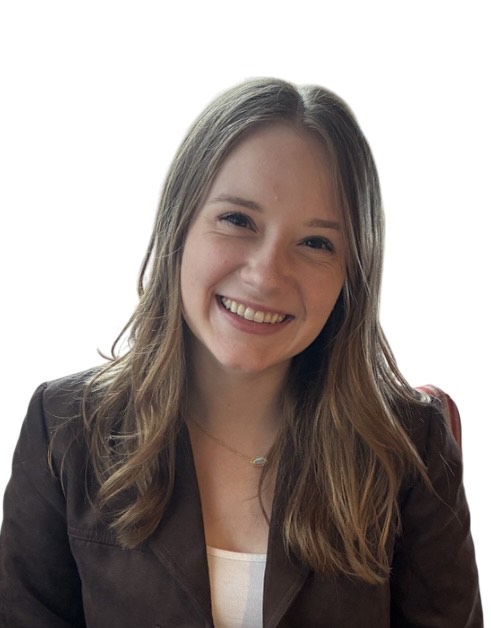 A person with long, wavy, light brown hair is shown from the shoulders up, wearing a dark blazer over a light-colored top. The background is plain white.