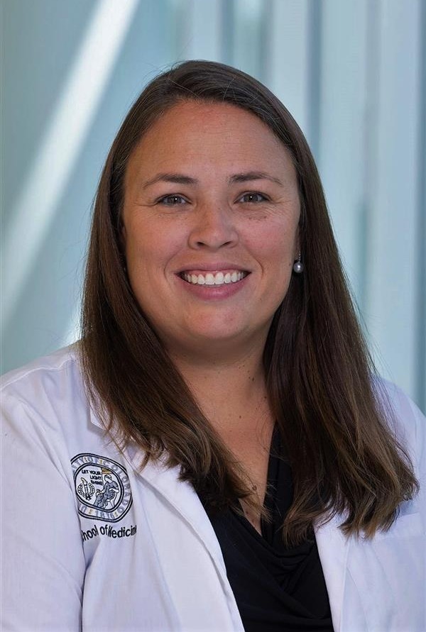 Professional headshot of woman in lab coat