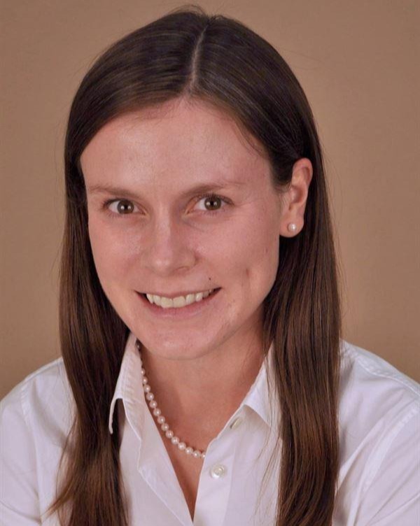 Headshot of woman in collared shirt