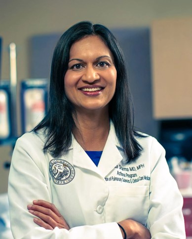 Professional headshot of woman in medical white coat