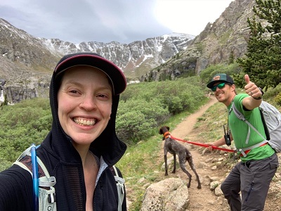 Sarah Poinski-McCoy with husband and dog hiking