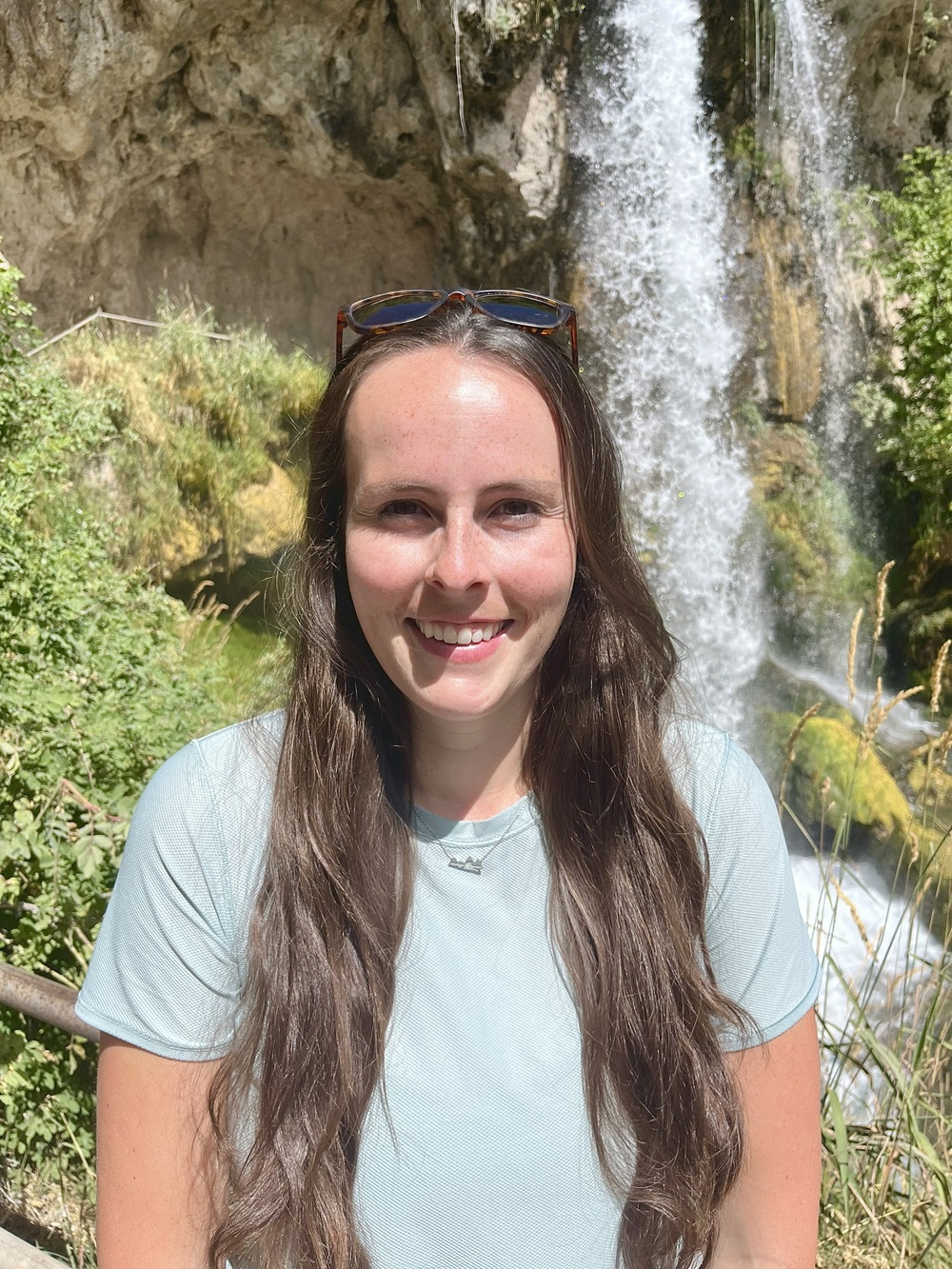 Dr. Kinniburgh standing in front of a waterfall.
