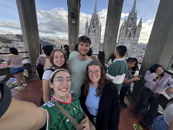 CU PT students exploring Ecuador, standing in front of a cathedral.