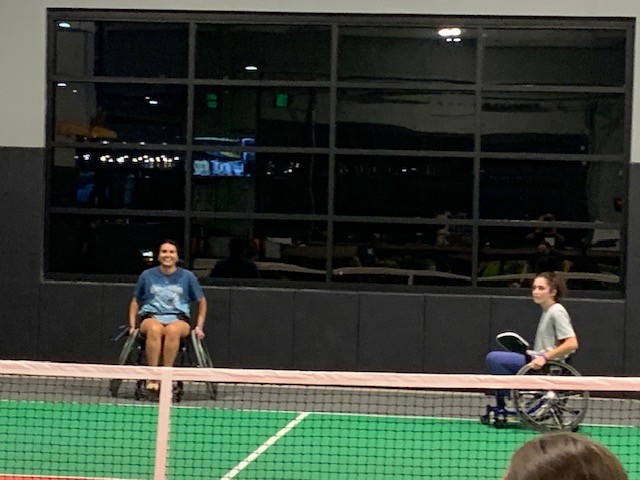 People playing pickleball in wheelchairs.