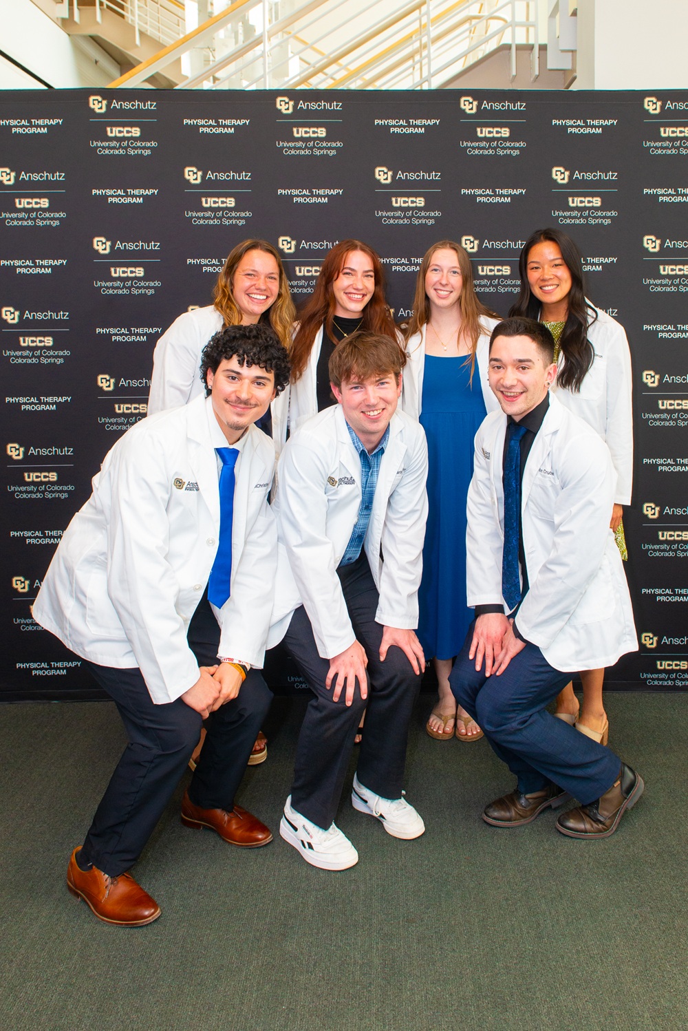 Class of 2028 students posing in front of a CU Physical Therapy banner.